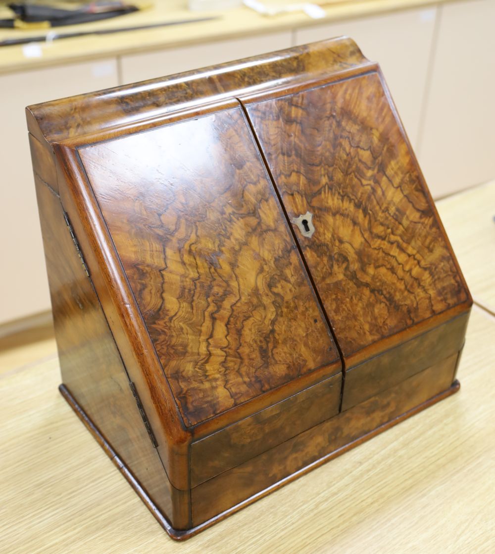 A Victorian figured walnut table stationery cabinet